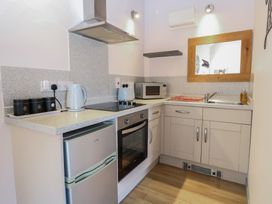 A kitchen with appliances and cabinetry at Snowy Owl Barn in Shipdham