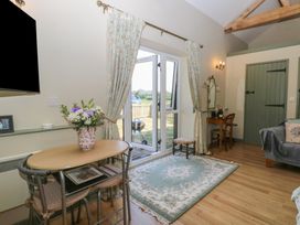 A living room with a table and chairs at Tawny Owl Barn Shipdham near Dereham