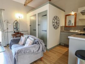 A living room with a sofa and table at Tawny Owl Barn Shipdham near Dereham