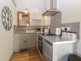 A kitchen with appliances and storage at Tawny Owl Barn Shipdham near Dereham
