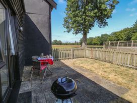 An outdoor area with a table and chairs at Tawny Owl Barn Shipdham near Dereham