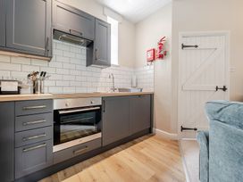 A kitchen with oven and sink at Can Brow at the Graythwaite Estate near Hawkshead