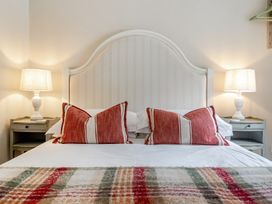 A bedroom with a bed and lamps at Can Brow at the Graythwaite Estate near Hawkshead
