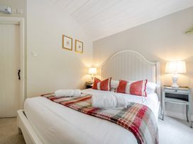 A bedroom with a bed and bedside table at Can Brow at the Graythwaite Estate near Hawkshead