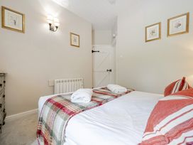 A bedroom with a bed and wall art at Can Brow at the Graythwaite Estate near Hawkshead