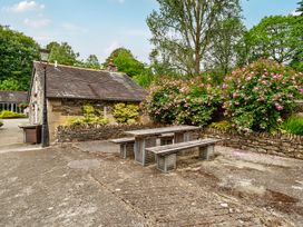 An outdoor area with a table and chairs at Can Brow at the Graythwaite Estate near Hawkshead