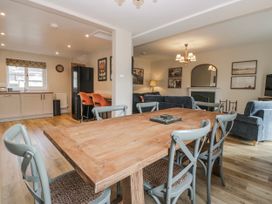 A dining room with a wooden table and chairs at Jubilee near Hawkshead