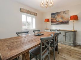 A dining room with a wooden table and chairs at Jubilee in Graythwaite near Hawkshead