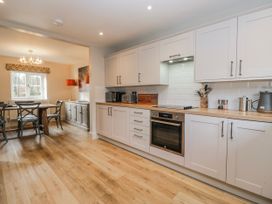 A kitchen with cabinets and dining area at Jubilee in Graythwaite near Hawkshead