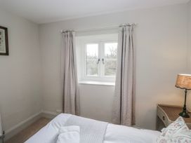 A bedroom with a bed and window at Jubilee in Graythwaite near Hawkshead