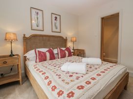 A bedroom with a bed and bedside table at Jubilee in Graythwaite near Hawkshead