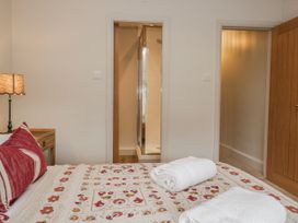 A bedroom with a bed and towels at Jubilee in Graythwaite near Hawkshead