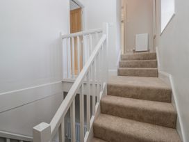 A staircase with carpet and handrail at Jubilee in Graythwaite near Hawkshead