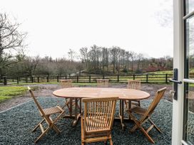 An outdoor dining area with a table and chairs at Jubilee near Graythwaite