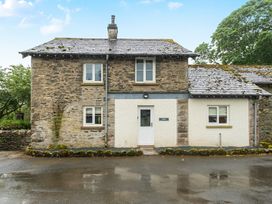 A cottage with stone walls and a front door at Jubilee at the Graythwaite Estate near Hawkshead