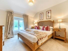 A bedroom with a bed and bedside tables at Jubilee at the Graythwaite Estate Graythwaite near Hawkshead