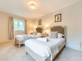 A bedroom with two beds and nightstands at Jubilee at the Graythwaite Estate Graythwaite near Hawkshead