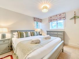 A bedroom with a bed and dresser at Jubilee at the Graythwaite Estate, Graythwaite near Hawkshead
