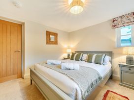 A bedroom with a bed and bedside tables at Jubilee at the Graythwaite Estate in Graythwaite near Hawkshead