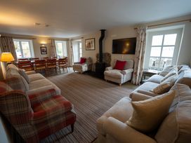 A living room with sofas and a dining area at Hammerhole in Graythwaite near Hawkshead