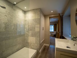 A bathroom with a shower and vanity unit at Hammerhole in Graythwaite near Hawkshead