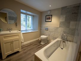 A bathroom with a sink, toilet, and bathtub at Hammerhole in Graythwaite near Hawkshead