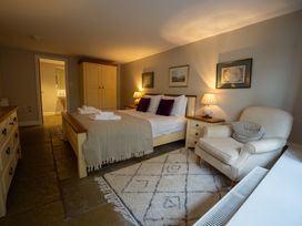 A bedroom with a bed and nightstand at Hammerhole in Graythwaite near Hawkshead