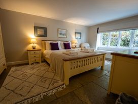 A bedroom with a bed and nightstand at Hammerhole in Graythwaite near Hawkshead