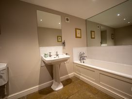 A bathroom with a sink and bathtub at Hammerhole in Graythwaite near Hawkshead