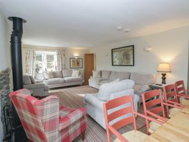 A living room with seating and a dining table at Hammerhole in Graythwaite near Hawkshead