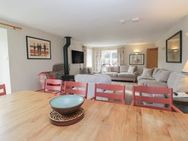 A living room with a dining table and sofas at Hammerhole in Graythwaite near Hawkshead
