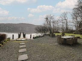 An outdoor dining area with a view of the lake at Hammerhole in Graythwaite near Hawkshead