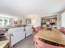 A living room with a sofa and dining table at Hammerhole at the Graythwaite Estate near Hawkshead