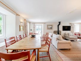 A dining room with a large table and chairs at Hammerhole at the Graythwaite Estate near Hawkshead