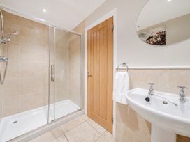 A bathroom with a shower and sink at Hammerhole at the Graythwaite Estate near Hawkshead