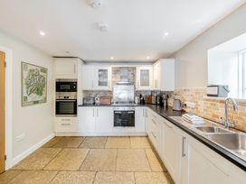 A kitchen with appliances and stone flooring at Hammerhole at the Graythwaite Estate near Hawkshead