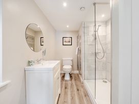 A bathroom with a sink, toilet, and shower at Hammerhole at the Graythwaite Estate near Hawkshead