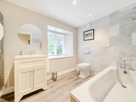 A bathroom with a bath and toilet at Hammerhole at the Graythwaite Estate near Hawkshead