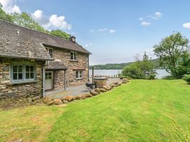 An outdoor area with a house and lake at Hammerhole at the Graythwaite Estate Graythwaite Estate near Hawkshead