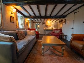 A living room with a sofa, armchairs, and coffee table at Hullet Hall, Graythwaite near Hawkshead