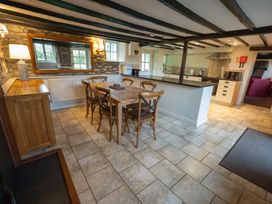 A kitchen with a table and chairs at Hullet Hall in Graythwaite near Hawkshead