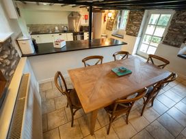 A dining room with a wooden table and chairs at Hullet Hall Graythwaite near Hawkshead