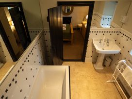 A bathroom with a bathtub and sink at Hullet Hall in Graythwaite near Hawkshead