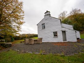 A house with outdoor furniture and gravel at Hullet Hall Graythwaite near Hawkshead