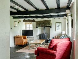 A living room with a sofa, armchair and coffee table at Hullet Hall at the Graythwaite Estate near Hawkshead