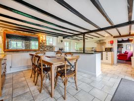 A kitchen with a dining table and chairs at Hullet Hall at the Graythwaite Estate near Hawkshead