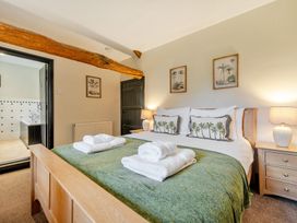 A bedroom with a bed and towels at Hullet Hall at the Graythwaite Estate near Hawkshead