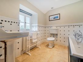 A bathroom with a sink, toilet, and bathtub at Hullet Hall at the Graythwaite Estate near Hawkshead