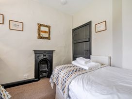 A bedroom with a bed and fireplace at Hullet Hall at the Graythwaite Estate near Hawkshead