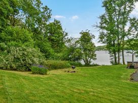 A garden with trees and water at Hullet Hall at the Graythwaite Estate near Hawkshead